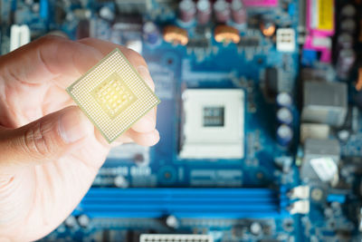 High angle view of hand holding cpu