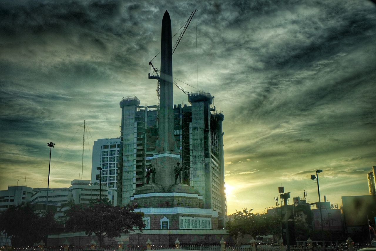 architecture, building exterior, built structure, sky, cloud - sky, city, cloudy, tower, tall - high, low angle view, skyscraper, capital cities, travel destinations, cloud, famous place, weather, overcast, building, city life, modern