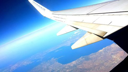 Cropped image of airplane flying over sea