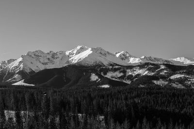 Scenic view of snowcapped mountains against clear sky