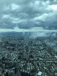 High angle view of modern buildings in city against sky