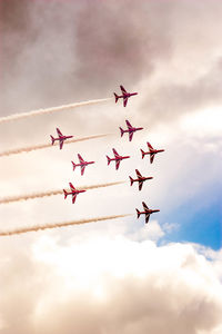 Low angle view of airshow against sky