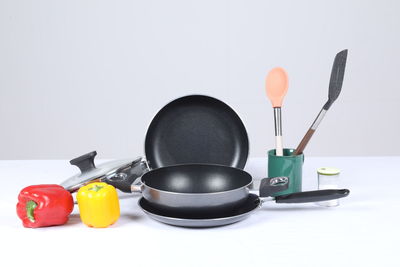 Close-up of red chili peppers against white background