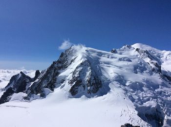 Scenic view of mountains against cloudy sky