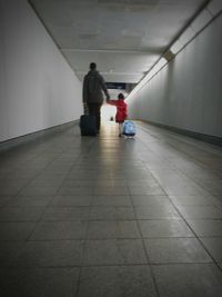 Rear view of people walking in corridor