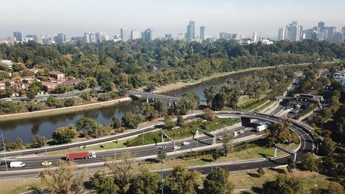 High angle view of trees and buildings in city against sky