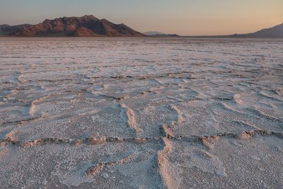 Scenic view of desert against sky during sunset