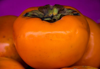 Close-up of pumpkin against orange background