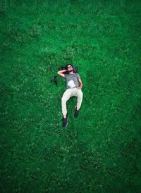 High angle view of man lying down on land