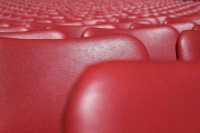 Full frame shot of empty red chairs in stadium