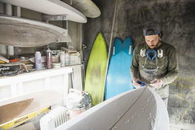 Surfboard shaper refining a new design