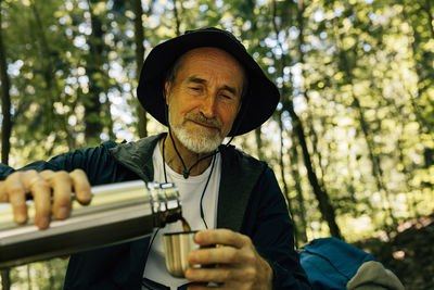 Portrait of young man drinking water