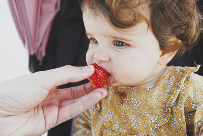 Close-up portrait of cute baby eating food