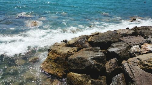 High angle view of rocks at sea shore