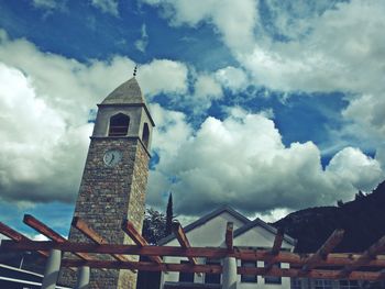 Low angle view of church against cloudy sky