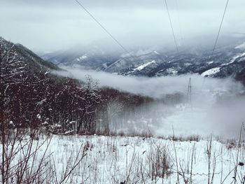 Snow covered landscape against sky