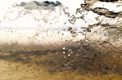 Close-up of water splashing in glass