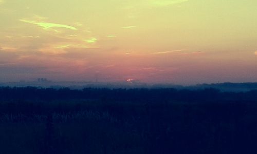 Scenic view of silhouette landscape against sky at sunset
