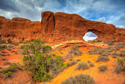 Scenic view of rock formation against cloudy sky