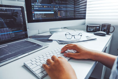 Midsection of man using laptop on table