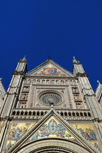 Low angle view of building against blue sky