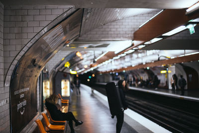 People waiting at railroad station platform