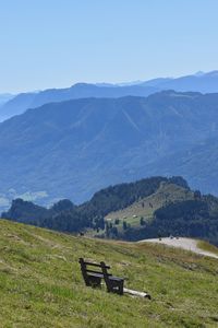 Scenic view of field and mountains against sky