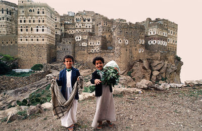 Young couple standing against built structure