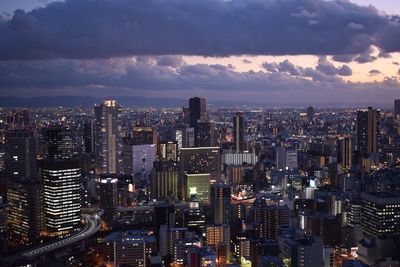 Aerial view of illuminated cityscape against sky