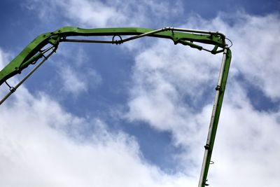 Low angle view of crane against sky