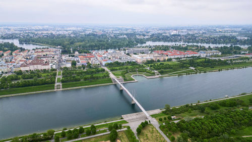 High angle view of townscape by sea against sky