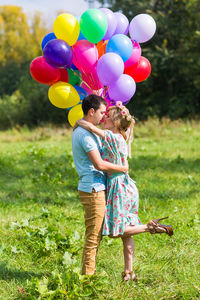 Rear view of two women holding balloons