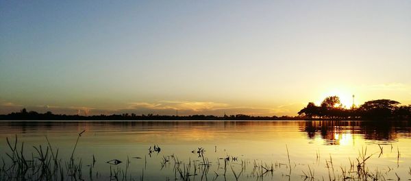 Scenic view of lake against sky during sunset