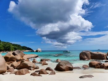 Rocks on beach against sky