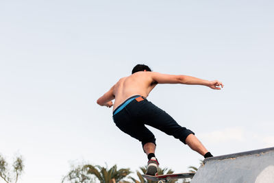 Young skater standing at the top of the skate ramp