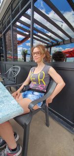 Portrait of a smiling young woman sitting on seat