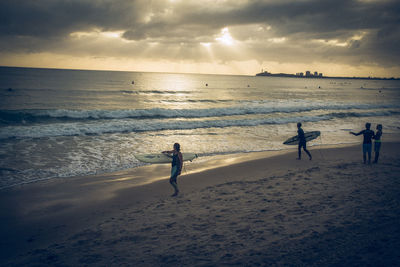 People on beach against sky