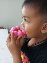 Close-up of boy eating donut