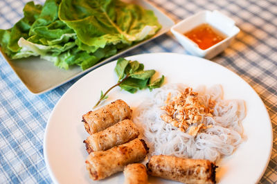 High angle view of asian food in plate on table