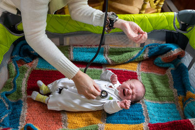 High angle view of father holding hands