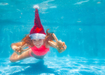 Young man swimming in pool