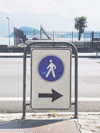 Road sign against sky