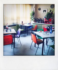 Empty chairs and tables in restaurant