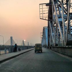 Bridge in city at sunset