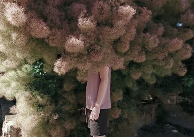 Man standing by tree