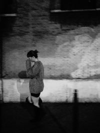 Side view of a woman walking on street in city