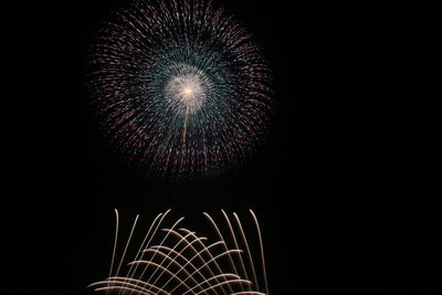 Low angle view of firework display against sky at night