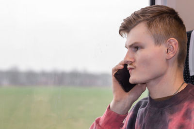 Busy man calling on smartphone when he traveling by train. man talking about business matters.