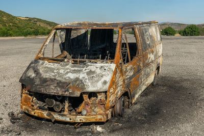 Old rusty car on road