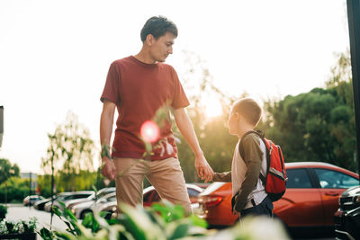 Happy father and kid son going to classes. parent take child boy to school in first grade. pupil 